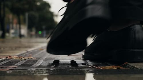 Business Man Tourist Person with Umbrella and Raincoat on Rainy European City Street Lights