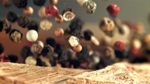 Falling Multi Colored Peppercorns in Slow Motion
