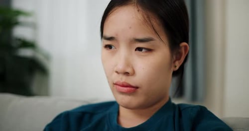 Woman Smiling While Sitting on Couch Indoors