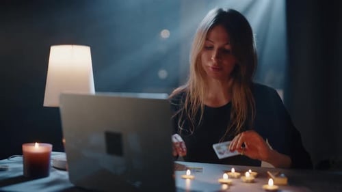 Woman Reads Tarot Cards Online with Candles