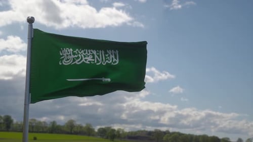 Saudi Arabia Flag Waving Realistically Under a Blue Sky