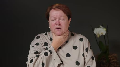 Woman Sick with Flu Coughing and Blowing Her Nose on Her Bed at Home Having Sore Throat Fever and