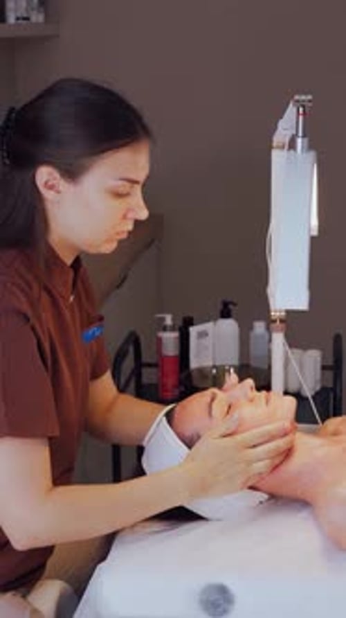 Woman Receives Facial Massage in a Peaceful Beauty Salon