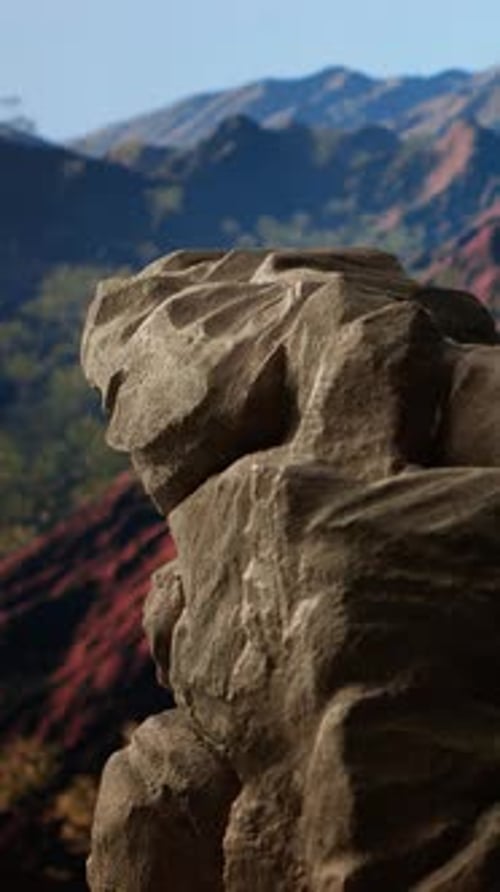 Vertical Video Rugged Rocky Ledge Overlooks a Breathtaking Mountain Range