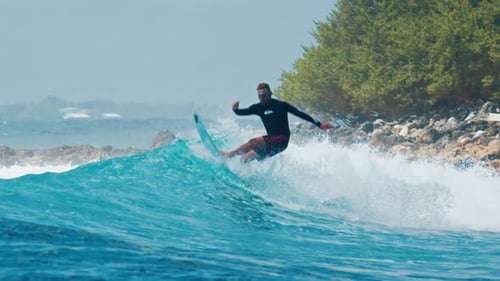 Man Surfs the Ocean Wave