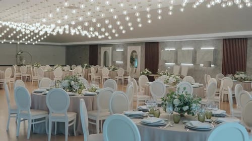 Wedding reception hall with round tables floral centerpieces