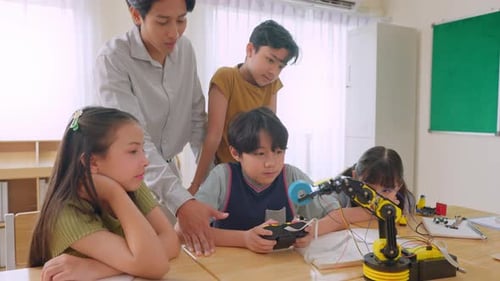 Group of students learning in a robotics class at elementary school.