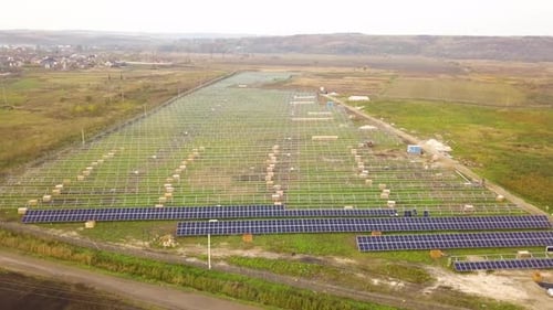 Aerial View of Solar Power Plant Under Construction on Green Field