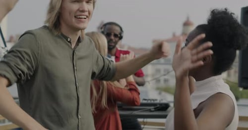 Happy Friends Dancing on Urban Rooftop Party