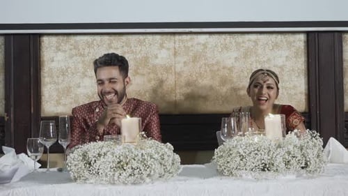 Newlywed Indian Couple On Their Wedding Reception Table. Close-up Shot