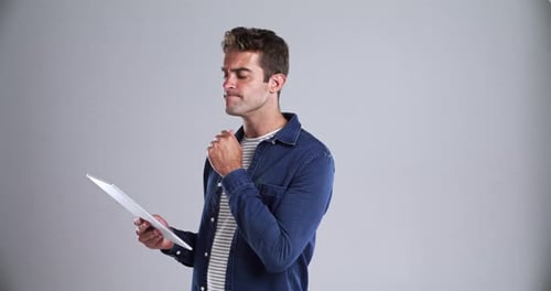 Business, man and tablet in studio with thinking, question and ideas for marketing career at work