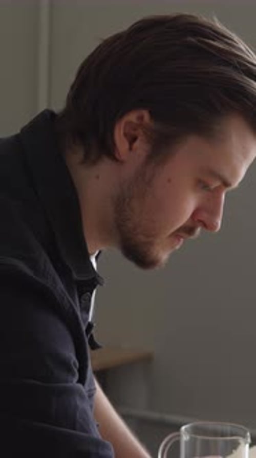 A Contemplative Man Enjoys His Moment of Deep Reflection Within a Cozy Cafe Ambiance Media