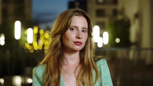 Young Woman in Green Blazer Looking at Camera