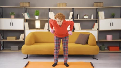 Old woman using dumbbells is healthy and fit.