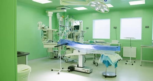 Modern Operating Room with Green Walls and Advanced Medical Equipment