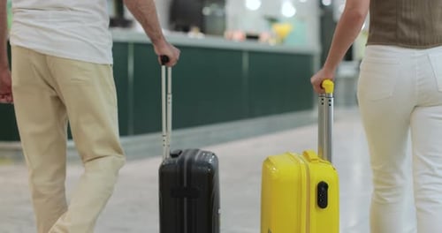 Close Up Tourists Arriving with Suitcase at Hotel Front Desk Two People with Luggage Checking in