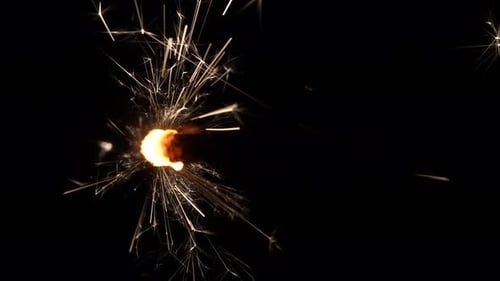 Burning Sparkler Emitting Golden Light in the Dark