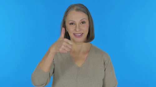 Woman Giving Thumbs Up on Blue Background