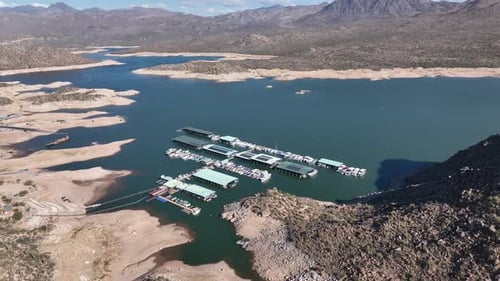 Aerial view of serene lake and marina with mountains, United States.