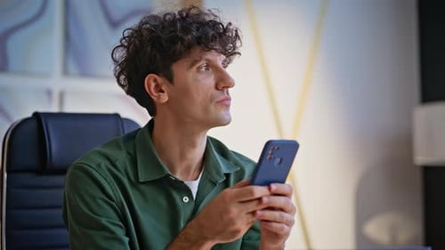 Entrepreneur Browsing Banking App at Cellphone Feeling Satisfied Office Closeup