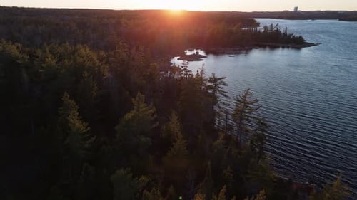 Cinematic Drone View of a Wild Forest and Lake Long Lake with a Beautiful Sunset