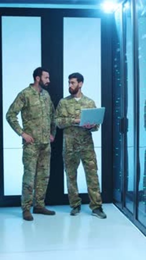 Soldiers Inspecting Servers with Laptop in Data Center