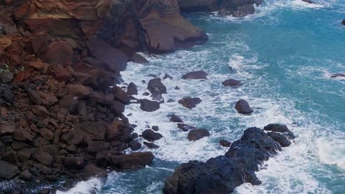 Waves Crashing on Rocky Shoreline in Ocean Water