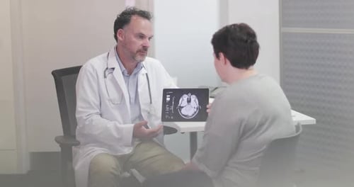 Doctor Explains Brain Scan to Patient in Office