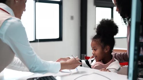 Mother and cute toddler girl do flight check boarding pass at the airport,Family trip.