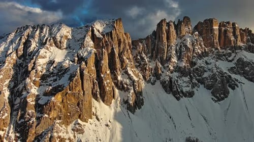 Rocky Snow Mountains at Sunset Aerial