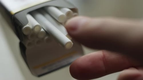 A Hand Takes a Cigarette From an Open Pack on the Table Bad Habit Risk of Heart and Lung Disease