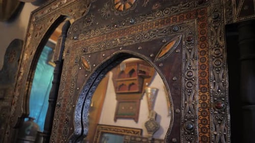 Golden retro mirror frame, baroque style. Vintage interior with a mirror in a beautiful frame and ar