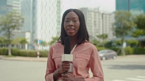 Reporter Speaking in City with Microphone