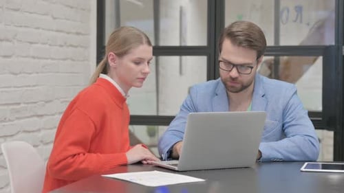 Business People Discussing Project while Sitting in Office