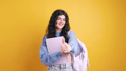 Smiling Student Gives Thumbs Up With Backpack