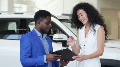 Professional Man and Woman Negotiating Car Purchase Agreement