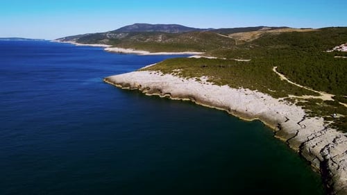 Scenic view of a drone shot on the rocky coast and a beach on a tropical island. A beautiful Mediter