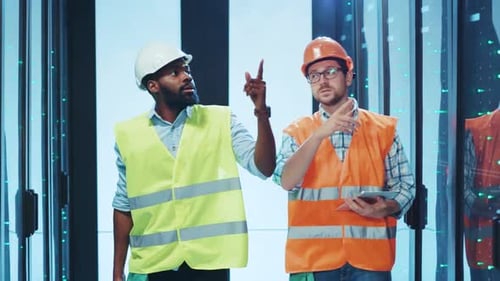 Two Dedicated Construction Workers are Engaged in Tasks Within a Data Center Environment