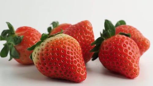 Strawberries rotate on a white background.