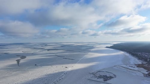 Aerial Drone View of Frozen Sea Bay Under a Cloudy Winter Sky
