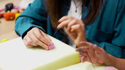 Participants Create Colorful Felt Ornaments Through Needle Felting Activities