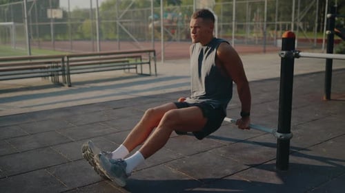 Man Exercising Outdoors Doing Tricep Dips in Urban Park Fitness Area