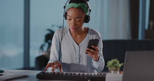 Woman Creates Music in Home Studio with Keyboard