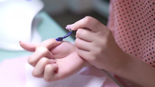 Close Up Hands Woman Manicurist Delicately Painting Nail with Gel Polish