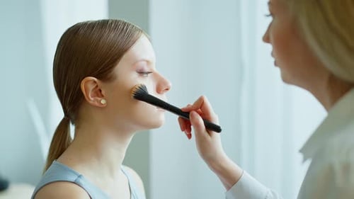 Makeup Artist Work in Her Beauty Studio Portrait of Woman Applying By Professional Make Up Master