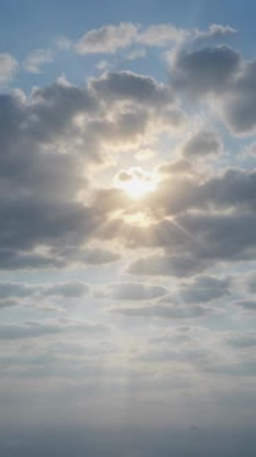 Vertical Footage of Bright Sunlight Beaming Through Clouds