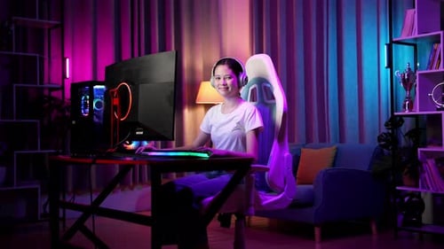 Young Woman Playing Computer Game With LED Lights