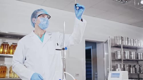 Scientists Working with Vials in a White Lab