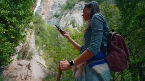 Woman Hiker Taking Photo in Forest Canyon