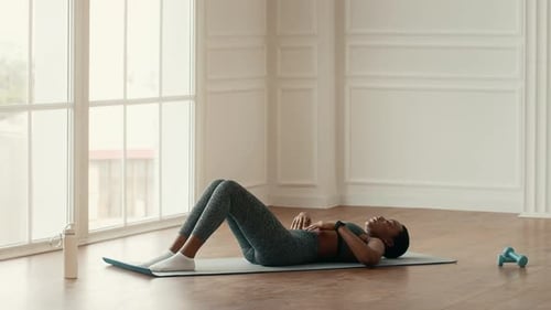 Woman Doing Sit-Ups at Home for Health